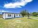 Beautiful home showcasing a charming covered porch, a well-maintained lawn, and fresh landscaping, perfect for curb appeal at 5290 101St Ave, Pinellas Park, FL 33782