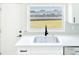 Bright white kitchen with stainless steel sink and quartz countertops overlooking the backyard at 5290 101St Ave, Pinellas Park, FL 33782