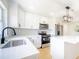 Kitchen with stainless steel appliances, bright white cabinets, quartz counters, and an island at 5290 101St Ave, Pinellas Park, FL 33782