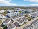 Expansive aerial view of a community showcasing modern townhomes, apartments, a serene pond, and lush green landscaping at 5351 Bridge St # 15, Tampa, FL 33611