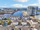 Stunning aerial view of waterfront townhomes and a modern high-rise with water views and a bridge in the background at 5351 Bridge St # 15, Tampa, FL 33611