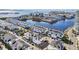 Aerial view of modern white townhomes with dark roofs, surrounded by a tranquil waterfront setting and manicured landscaping at 5351 Bridge St # 15, Tampa, FL 33611