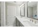 A pristine bathroom with double sinks, a mirror, and a glass-enclosed shower at 5351 Bridge St # 15, Tampa, FL 33611