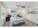 Cozy bedroom with beach-themed decor, a ceiling fan, and comfortable bedding at 5351 Bridge St # 15, Tampa, FL 33611