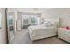 Bright bedroom with a chandelier, two windows, and gray and white bedding at 5351 Bridge St # 15, Tampa, FL 33611