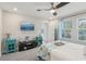 Bright bedroom with a ceiling fan, large windows, and comfortable furnishings at 5351 Bridge St # 15, Tampa, FL 33611