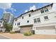 Three-story townhouse with white exterior, black shutters, and a brick driveway at 5351 Bridge St # 15, Tampa, FL 33611