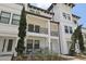 A bright, white townhome with large balconies and well-maintained landscaping at 5351 Bridge St # 15, Tampa, FL 33611