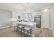 Bright kitchen with white cabinets, stainless steel appliances, and spacious island with seating at 5351 Bridge St # 15, Tampa, FL 33611