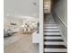 Bright living room features an open floor plan with wood floors and modern decor leading to the staircase at 5351 Bridge St # 15, Tampa, FL 33611