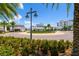 Charming street view with tropical landscaping, roundabout, and inviting storefronts in a vibrant community at 5351 Bridge St # 15, Tampa, FL 33611