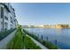 Scenic waterfront view along a pedestrian walkway with modern townhomes, manicured greenery, and a tranquil lagoon setting at 5351 Bridge St # 15, Tampa, FL 33611
