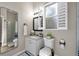 Well-lit bathroom with a single sink vanity and plantation shutters at 5605 Glencrest Blvd, Tampa, FL 33625