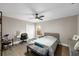 Bedroom featuring a ceiling fan, desk, closet and gray flooring at 5605 Glencrest Blvd, Tampa, FL 33625