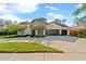 Stately home with elegant landscaping, circular driveway, and a three-car garage at 5605 Glencrest Blvd, Tampa, FL 33625
