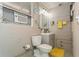 Bathroom featuring toilet, sink, mirror, and neutral color palette at 5638 13Th N Ave, St Petersburg, FL 33710
