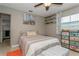 Pleasant bedroom showcasing a ceiling fan, decorative shelving, and a comfortable bed at 5638 13Th N Ave, St Petersburg, FL 33710