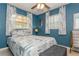 Inviting bedroom with a ceiling fan, soft natural lighting, and stylish window treatments at 5638 13Th N Ave, St Petersburg, FL 33710