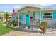 Cozy front porch with blue shutters, a 'WELCOME' sign, and a small seating area at 5638 13Th N Ave, St Petersburg, FL 33710