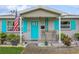 Close-up of the home's entrance, showing the blue door, shutters, and stone details at 5638 13Th N Ave, St Petersburg, FL 33710