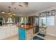 Kitchen showcasing a large stainless steel refrigerator, kitchen island, natural light, and an open concept to living area at 5638 13Th N Ave, St Petersburg, FL 33710