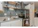 Kitchen area showcasing stainless steel appliances, and floating shelves with stylish gray tiled backsplash at 5638 13Th N Ave, St Petersburg, FL 33710