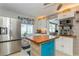 Eat-in kitchen featuring stainless steel refrigerator, kitchen island with a wood top, and lots of natural light at 5638 13Th N Ave, St Petersburg, FL 33710