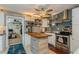 Charming kitchen boasts stainless steel appliances, stylish backsplash, and an island with wood countertop at 5638 13Th N Ave, St Petersburg, FL 33710