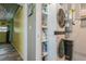 Convenient laundry room featuring a stacked washer and dryer with storage and wood-look flooring at 5638 13Th N Ave, St Petersburg, FL 33710