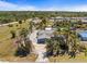 A serene neighborhood showcases lush greenery and single-Gathering homes with tropical trees at 595 Denburn Ct, Englewood, FL 34223