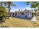 A backyard features lush tropical plants, a winding walkway, and a serene atmosphere at 595 Denburn Ct, Englewood, FL 34223