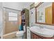 Bathroom features a sink and vanity, toilet, and shower with colorful curtain at 595 Denburn Ct, Englewood, FL 34223