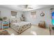 Bright and airy bedroom features a comfortable queen bed, ceiling fan, and plenty of natural light at 595 Denburn Ct, Englewood, FL 34223