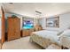 Bright bedroom with tropical decor, comfortable furnishings, and plenty of natural light from the windows at 595 Denburn Ct, Englewood, FL 34223