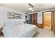 Bedroom with tropical decor, comfortable queen bed, and access to bathroom at 595 Denburn Ct, Englewood, FL 34223