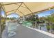 Spacious covered boat dock featuring stylish outdoor furniture and direct water access at 595 Denburn Ct, Englewood, FL 34223
