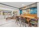 Charming dining area features a unique wooden table and chairs, adjacent to a bright sunroom with tiled floors at 595 Denburn Ct, Englewood, FL 34223