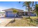 Charming single-story home with a well-maintained front yard and attached garage at 595 Denburn Ct, Englewood, FL 34223