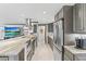 Well-appointed kitchen with stainless appliances and a breakfast bar for casual dining at 595 Denburn Ct, Englewood, FL 34223