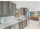 Updated kitchen showcasing stylish cabinets, stainless steel appliances, and a tiled backsplash at 595 Denburn Ct, Englewood, FL 34223