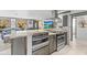 Spacious kitchen features granite countertops, stainless appliances, and opens to the living area at 595 Denburn Ct, Englewood, FL 34223