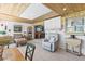 Open living room features tile floors, unique furnishings and bright light from windows and skylight at 595 Denburn Ct, Englewood, FL 34223