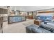 Open-concept living space with tile floors, a wooden bar, and comfortable leather seating at 595 Denburn Ct, Englewood, FL 34223