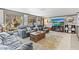 Comfortable living room featuring neutral tones, a turtle rug, and a large-screen television at 595 Denburn Ct, Englewood, FL 34223