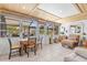Bright living room with tile floors, walls of windows for plenty of natural light and outside views at 595 Denburn Ct, Englewood, FL 34223