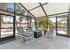 Enclosed patio featuring comfortable seating and a fire pit, perfect for outdoor relaxation and socializing at 595 Denburn Ct, Englewood, FL 34223
