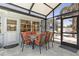 Covered patio with an outdoor dining set, providing a cozy space for al fresco meals and gatherings at 595 Denburn Ct, Englewood, FL 34223