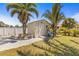 Exterior view of backyard storage shed on a sunny day with lush landscaping at 595 Denburn Ct, Englewood, FL 34223