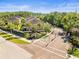 Gated community entrance with lush landscaping, mature trees, and well-maintained townhouse-style homes at 602 Cabernet Way, Oldsmar, FL 34677