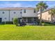 Spacious green backyard, grill and relaxing screened-in patio for leisure and enjoyment at 602 Cabernet Way, Oldsmar, FL 34677